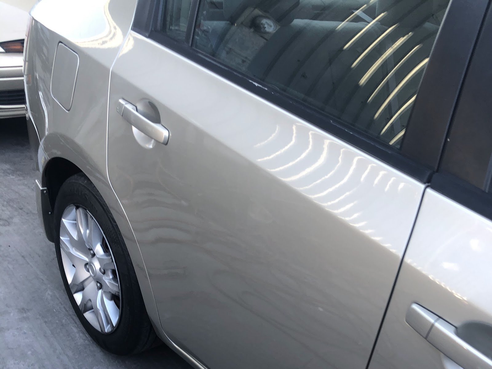 Customer's sedan with a smooth refinished quarter panel at Sako's